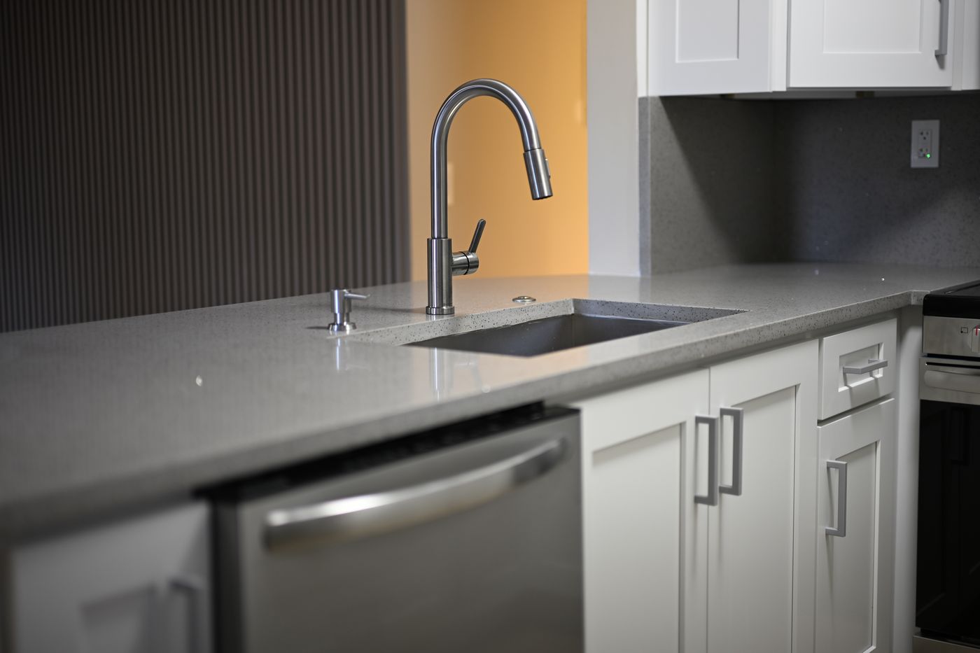 Gray cabinet kitchen with mosaic backsplash